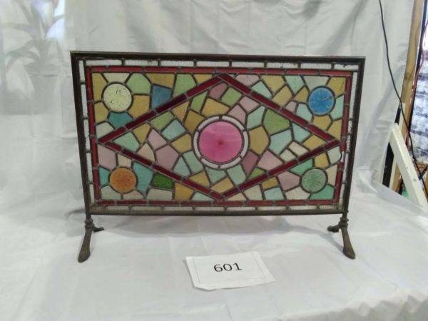 lot 601 Large stained glass fire screen with metal surround 32″ x  22.5″ ( some missing glass)