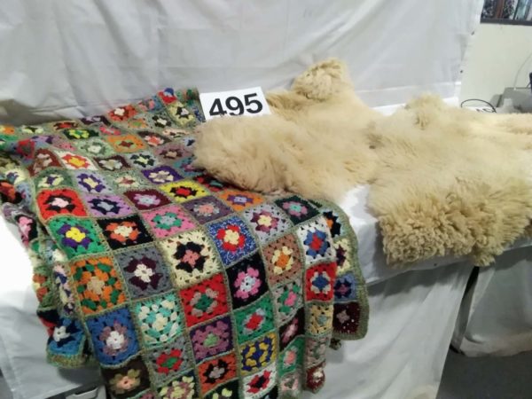 lot 495 sheep skin rugs x2 & crochet blanket