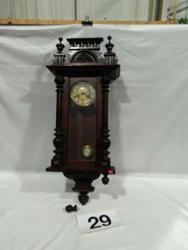 lot 029 wooden cased wall clock with key