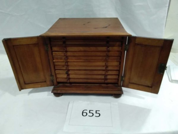 lot 655  antqiue storage / coin collectors cabinet plus some coins